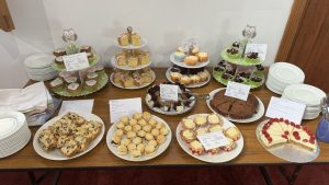 A table full of cakes on cake stands.